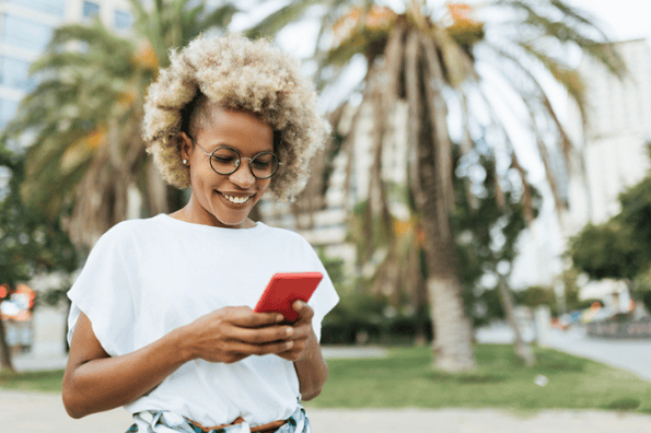 Woman smiling with red smartphone