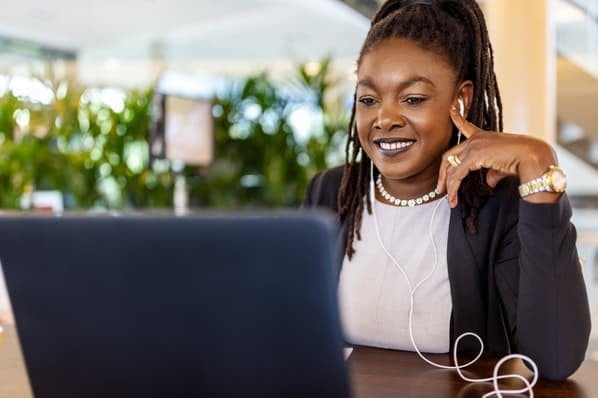 Woman smiling at laptop