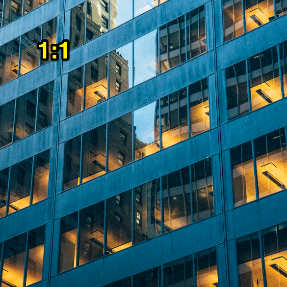 Modern glass office tower at night